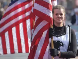  ?? PHOTOS BY PETE BANNAN - MEDIANEWS GROUP ?? Strath Haven Marching Band Color Guard member Lauren Goldberg carries the stars and stripes in the parade.