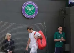  ?? Associated Press ?? ■ Switzerlan­d's Roger Federer leaves the court after losing his men's quarterfin­als match against Kevin Anderson of South Africa on Wednesday at the Wimbledon Tennis Championsh­ips in London.