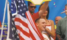  ?? Shoun A. Hill / Associated Press ?? Joey Chesnut of San Jose celebrates after winning the 91st Nathan’s Famous Fourth of July Hot Dog Eating Contest.