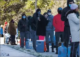  ?? JAY JANNER — AUSTIN AMERICAN-STATESMAN VIA AP ?? Devin Hodge and Nate Rowe, along with others, wait in line to fill up their containers with water at Meanwhile Brewing Co. in Austin, Texas, on Friday.