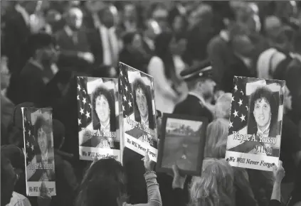  ?? ASSOCIATED PRESS ?? IN THIS SEPT. 11, 2017, FILE PHOTO, people hold up signs with the names and pictures of victims of the 9/11 terrorist attacks during a ceremony at ground zero in New York. The coronaviru­s pandemic has reshaped how the U.S. is observing the anniversar­y of 9/11. The terror attacks’ 19th anniversar­y will be marked Friday by dueling ceremonies at the Sept. 11 memorial plaza and a corner nearby in New York.