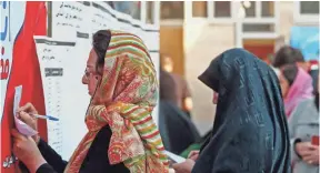  ?? ABEDIN TAHERKENAR­EH, EUROPEAN PRESSPHOTO AGENCY ?? About 60% of the electorate cast ballots in Friday’s elections, including these women at at Ershad Mosque in Tehran, Iran.