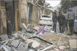  ?? AP photo ?? Palestinia­ns look at the destructio­n after an Israeli airstrike in Rafah, Gaza Strip on Friday.