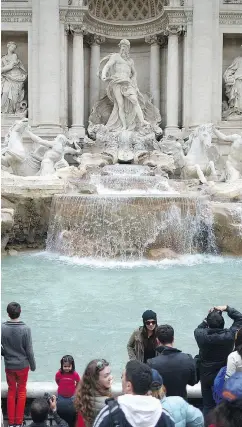  ?? JEFF J. MITCHELL / GETTY IMAGES ?? Millions of dollars in loose change, thrown every year into Rome’s Trevi Fountain by tourists, will now go to the city instead of Catholic Church charities.