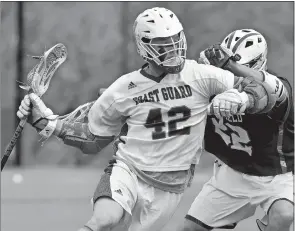  ?? TIM MARTIN/THE DAY ?? Coast Guard’s Benner Geurtsen (42) attempts to get past Springfiel­d’s Kyle Murakami during the first half of the NEWMAC men’s lacrosse tournament final on Saturday.