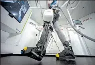  ?? AP/EUGENE HOSHIKO ?? Toyota Motor Corp.’s Welwalk WW-1000 system is made up of a motorized mechanical frame that fits on a person’s leg from the knee down.