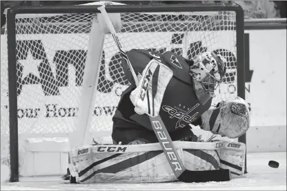  ?? The Associated Press ?? Washington Capitals goaltender Philipp Grubauer deflects a Vancouver Canucks shot during the third period in Washington on Tuesday.