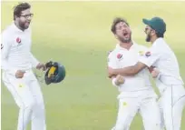  ??  ?? Pakistan’s Yasir Shah (centre) celebrates with team-mates after taking the wicket of New Zealand’s Trent Boult (unseen) on the fourth day of the second Test on Tuesday.