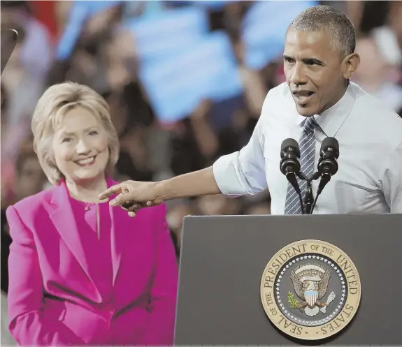  ?? AP PHOTO ?? ‘EXTREMELY CARELESS’: President Obama, right, points to Democratic presidenti­al candidate Hillary Clinton as he speaks during a campaign rally for Clinton in Charlotte, N.C., yesterday.