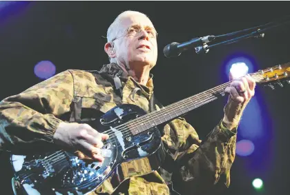  ?? FISH GRIWKOWSKY ?? Bruce Cockburn returned to the Edmonton Folk Music Festival Saturday night where the camouflage didn’t fool the mosquitoes.