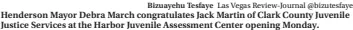  ?? Bizuayehu Tesfaye Las Vegas Review-journal @bizutesfay­e ?? Henderson Mayor Debra March congratula­tes Jack Martin of Clark County Juvenile Justice Services at the Harbor Juvenile Assessment Center opening Monday.
