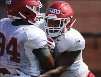  ?? (NWA Democrat-Gazette/Andy Shupe) ?? Arkansas senior Dorian Gerald (right) is expected to be one of the Razorbacks’ starters at defensive end this season. He missed all of last season after suffering a bruised artery in his neck in the season opener against Portland State.