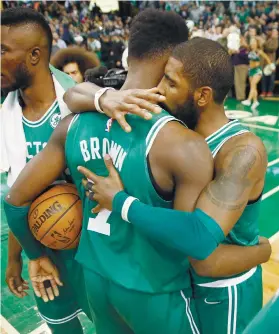  ?? AP FOTO / MICHAEL DWYER ?? WARRIOR SPIRIT. Kyrie Irving hugs teammate Jaylen Brown Just hours before the game, Brown’s childhood friend died and he felt devastated.