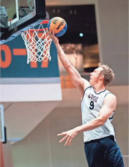  ?? COURTESY OF USA BASKETBALL ?? Former Florida basketball standout Canyon Barry scores for USA Basketball during a recent FIBA 3-on-3 basketball tournament. Barry will represent Team USA in 3-on-3 basketball in the 2024 Olympics this summer.