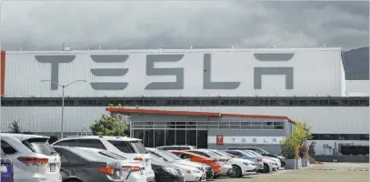  ?? Ben Margot Associated Press file ?? Electric vehicle and solar panel company Tesla is looking to raise up to $5 billion in capital through a stock offering.