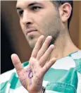  ??  ?? Anthony Comello, 24, displays the writing he scrawled on his hand during his hearing