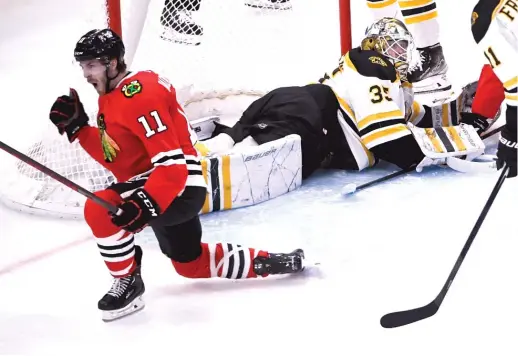  ?? MATT MARTON/AP ?? Right wing Taylor Raddysh celebrates one of the goals in his third-period hat trick against Bruins goaltender Linus Ullmark during the Blackhawks’ upset win Tuesday night at the United Center.