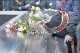  ?? RICHARD DREW — THE ASSOCIATED PRESS ?? Ed Schantz, representi­ng victims Monica Rodriguez Smith and her unborn daughter, kisses her name Monday during the 25th anniversar­y of the 1993 World Trade Center bombing.