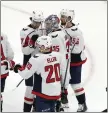  ?? MICHAEL DWYER – THE ASSOCIATED PRESS ?? Washington Capitals goalie Darcy Kuemper celebrates with teammates after defeating the Nhl-best Boston Bruins.