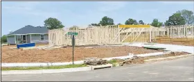  ?? (NWA Democrat-Gazette/Susan Holland) ?? Framing is up for new homes on Granite Circle in Stone Crest Subdivisio­n and other homes are nearing completion on the next street north. Nine new homes are under constructi­on in the subdivisio­n on Dallas Street S.W. and others will be started soon.