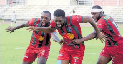  ?? ASHLEY ANGUIN PHOTOS ?? Montego Bay United’s Daniel Reid (centre) celebrates with his teammates Brian Brown (left) and Jourdain Fletcher after scoring their second goal.