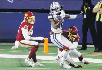  ?? THE ASSOCIATED PRESS ?? Washington’s Ryan Kerrigan, left, and Jeremy Reaves combine to stop Dallas wide receiver CeeDee Lamb during the second half in Arlington, Texas, on Thursday.