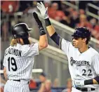  ?? BRAD MILLS / USA TODAY SPORTS ?? The Brewers’ Christian Yelich is congratula­ted by the Rockies’ Charlie Blackmon after hitting a home run in the eighth inning of the All-Star Game on Tuesday night at Nationals Park.