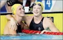  ??  ?? In this April 6, 2018 file photo, Australia’s Cate Campbell, (right), embraces her sister Bronte Campbell after their women’s 50m freestyle semifinal at the Aquatic Centre during the 2018 Commonweal­th Games on the Gold Coast, Australia. (AP)