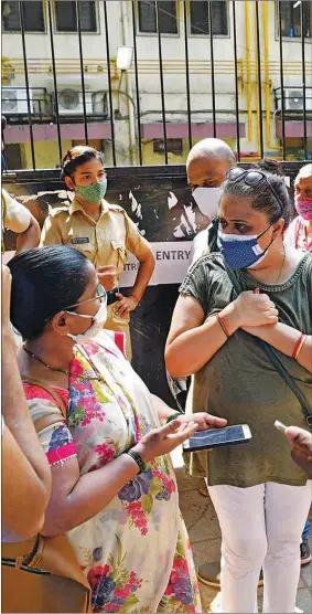  ??  ?? People stand outside a Mumbai vaccinatio­n centre yesterday which was closed due to the shortage of Covid-19 vaccines.