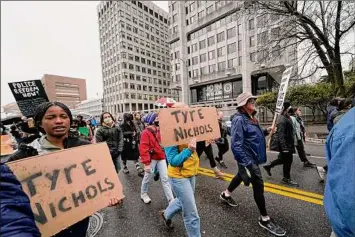  ?? Gerald Herbert / Associated Press ?? Protesters march in front of police headquarte­rs Saturday in Memphis, Tenn., after the death of Tyre Nichols, who died after being beaten by Memphis police.