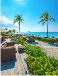  ??  ?? Above and far right: enjoy beachside lounging at Sandals Royal Bahamian. Below: alfresco dining at Sandals Emerald Bay.