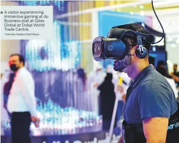  ?? Virendra Saklani/Gulf News ?? A visitor experienci­ng immersive gaming at du Business stall at Gitex Global at Dubai World Trade Centre.