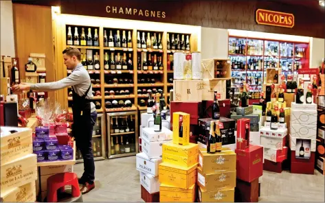  ?? REUTERS ?? Bottles of champagne are displayed at a Nicolas French wine specialist store in Paris, France on Tuesday.