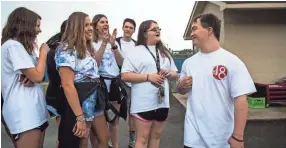  ??  ?? Ben Halvorson, 18, converses with fellow seniors about their college plans during Senior Day at Bartlett High School on Friday. Halvorson will be the first student in Bartlett City Schools to have Down Syndrome and graduate with a general education...