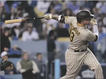  ?? AP PHOTO/ASHLEY LANDIS ?? San Diego Padres’ Manny Machado follows through on an RBI-double during the third inning in Game 2 of a baseball NL Division Series against the Los Angeles Dodgers, in 2022, in Los Angeles.