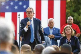  ?? JOHN MINCHILLO / AP ?? Gov. Mike Dewine and Dayton Mayor Nan Whaley compliment­ed each other on how they handled crises, including the mass shooting in the Oregon District.