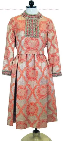  ?? [PHOTO PROVIDED BY UCO.] ?? Geoffrey Beene 1969 gold and coral brocade dress with gold trim and orange bead accents.