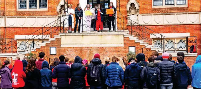  ??  ?? Having their say: Sixth-form pupils – many wearing red as a sign of support – make speeches at London’s Highgate School after classroom walkout yesterday