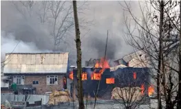  ?? — AFP ?? A house in which militants are suspected to have sheltered is in flames after a gunfight between militants and the security forces in South Kashmir’s Pulwama district, some 10 km away from the spot of the recent suicide bombing, on Monday.