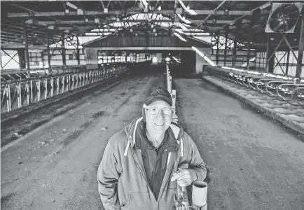  ?? ZACH BOYDEN-HOLMES/USA TODAY NETWORK ?? Eric Lyon stands in his family's empty dairy cow barn in Toledo, Iowa.