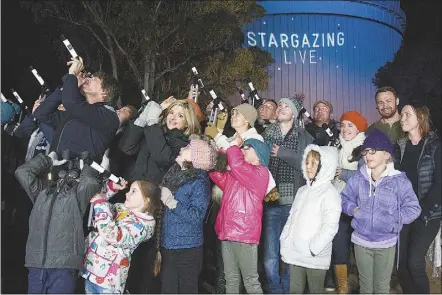  ??  ?? ABC’S Stargazing Live hosts Professor Brian Cox and Julia Zemiro are pictured with other Guinness World Record participan­ts at Siding Springs Observator­y last week. Students at Dubbo College also helped set a new world record for the most people...