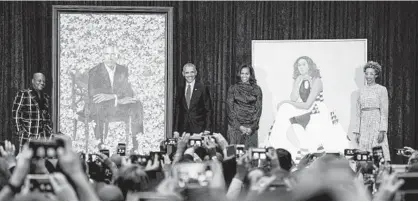  ?? ANDREW HARNIK/ASSOCIATED PRESS ?? The Obamas stand at the National Portrait Gallery with their portraits and the artists who painted them. From left, Kehinde Wiley, who painted Barack Obama; Barack Obama; Michelle Obama; and Baltimore’s Amy Sherald, who painted her portrait.