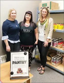  ?? MELANIE EKSAL/Special to The Daily Courier ?? From left, Courtney Kindlein, Natasha Mangel and Brianne Berchowitz pose with non-perishable food items that line the shelves at the Pantry, which is now open at Okanagan College in Kelowna to help students struggling to make ends meet.