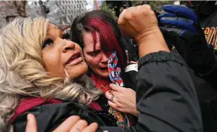  ?? Joshua Lott / Washington Post ?? Toshira Garraway, left, and Courteney Ross, girlfriend of George Floyd, react following the guilty verdict on all counts in Derek Chauvin’s trial in Minneapoli­s.