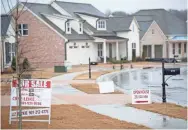  ?? MAX GERSH/THE COMMERCIAL APPEAL Federal Housing Finance Agency senior economist ?? Real estate signs are seen in the yards of homes throughout Piperton Preserve on Jan. 23 in Piperton.