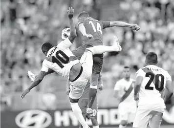  ?? AP Photo/Efrem Lukatsky ?? ■ Peru's Jefferson Farfan, left, and Denmark's Henrik Dalsgaard jump for a ball during the group C match between Peru and Denmark Saturday at the 2018 soccer World Cup in the Mordovia Arena in Saransk, Russia.