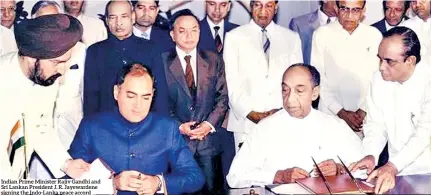  ??  ?? Indian Prime Minister Rajiv Gandhi and Sri Lankan President J. R. Jayewarden­e signing the Indo-lanka peace accord