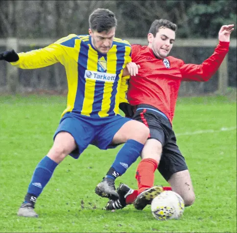  ?? Picture: Paul Amos FM6332891 ?? Charing (red) ease the ball from Lenham Wanderers Reserves on Saturday