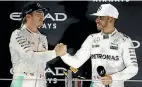  ??  ?? Mercedes team-mates Nico Rosberg and Lewis Hamilton shake on the podium.