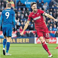  ??  ?? Tale of two scorers: Jamie Vardy looks forlorn as Federico Fernandez celebrates his goal